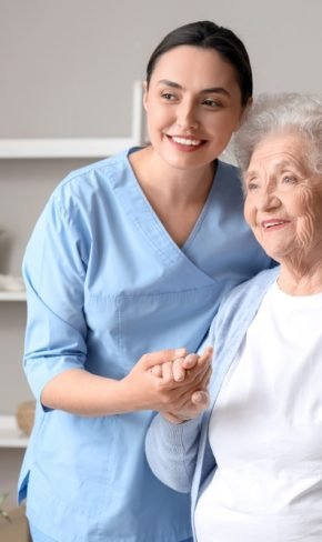 Senior,Woman,With,Physical,Therapist,Hugging,At,Home Senior,Woman,With,Physical,Therapist,Hugging,At,Home